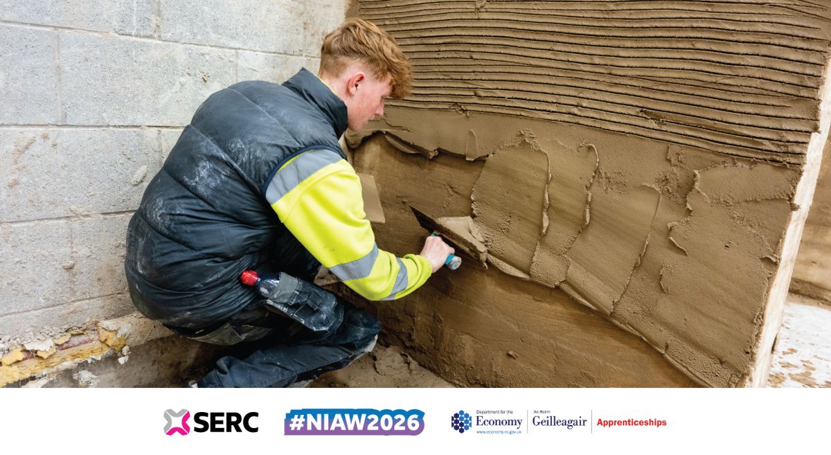 Image showing plastering student applying render to a wall. 